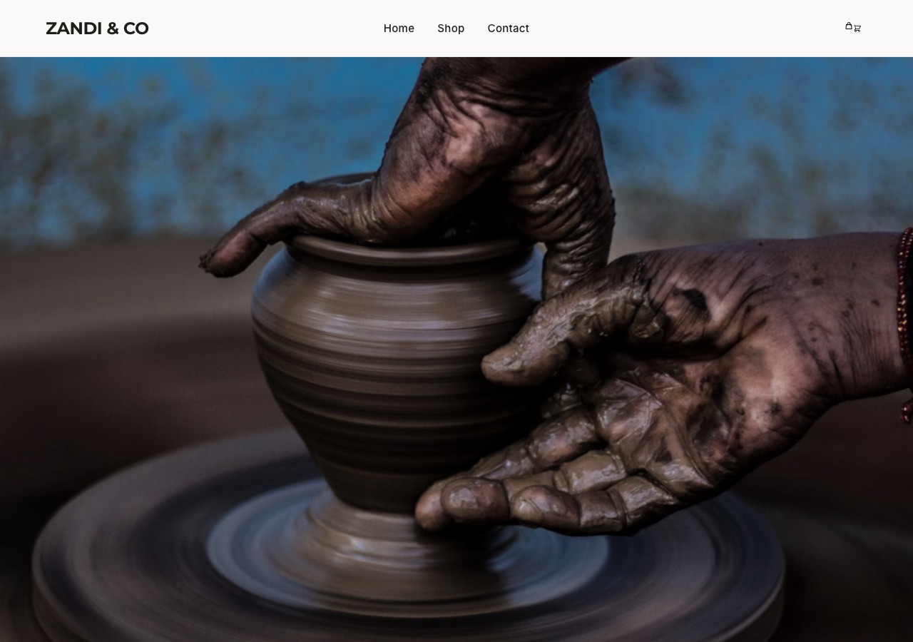 An online store opening on a full-width photograph of handmade ceramics